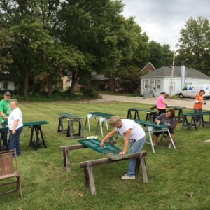 Volunteers work on shutters from Miller Fiege Home